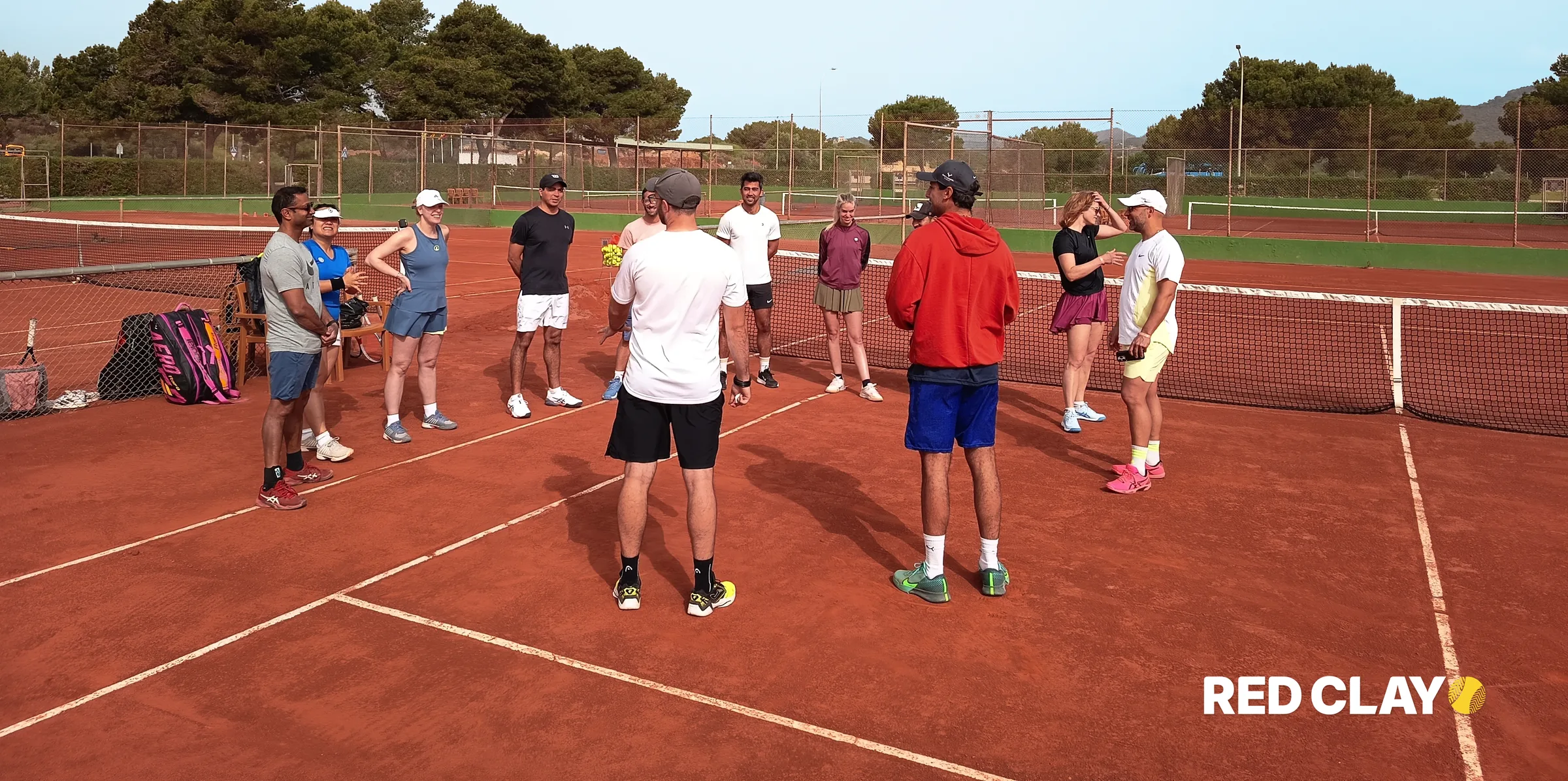 Group coaching session on red clay