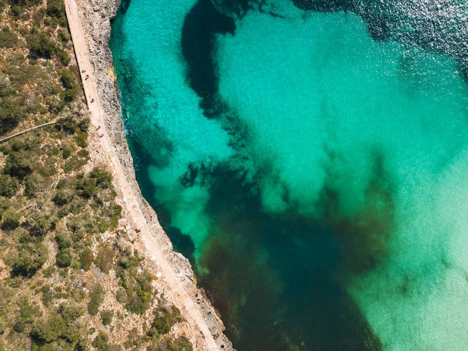 Turquoise cove and coastal path on Mallorca's east coast